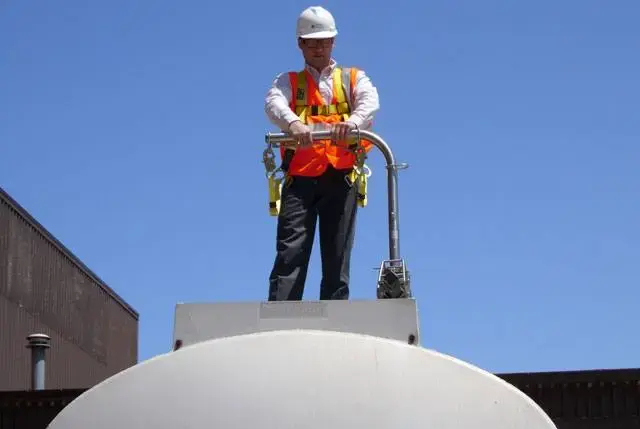 Tank truck driver on top of trailer with SFTram fall protection system