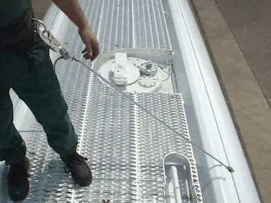 Man using bi-line system atop tanker truck